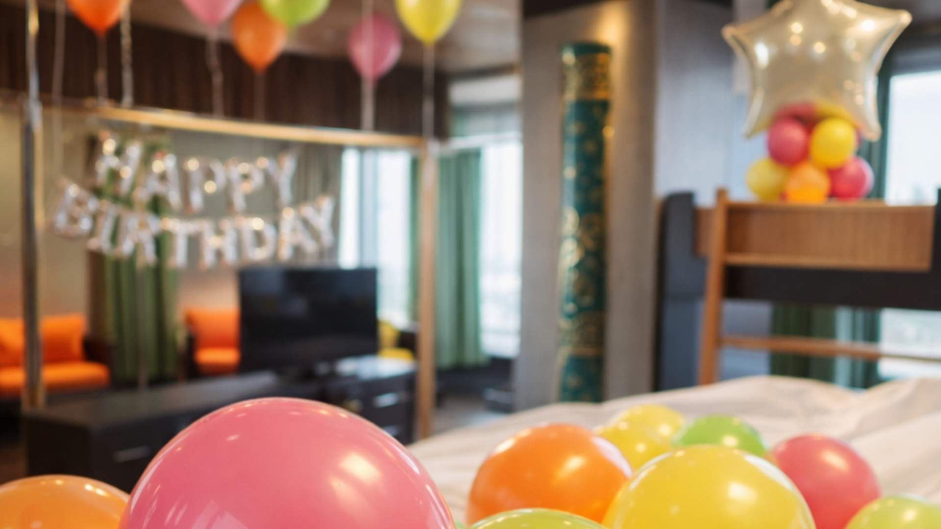 Birthday party setup with balloons and decorations in a room.