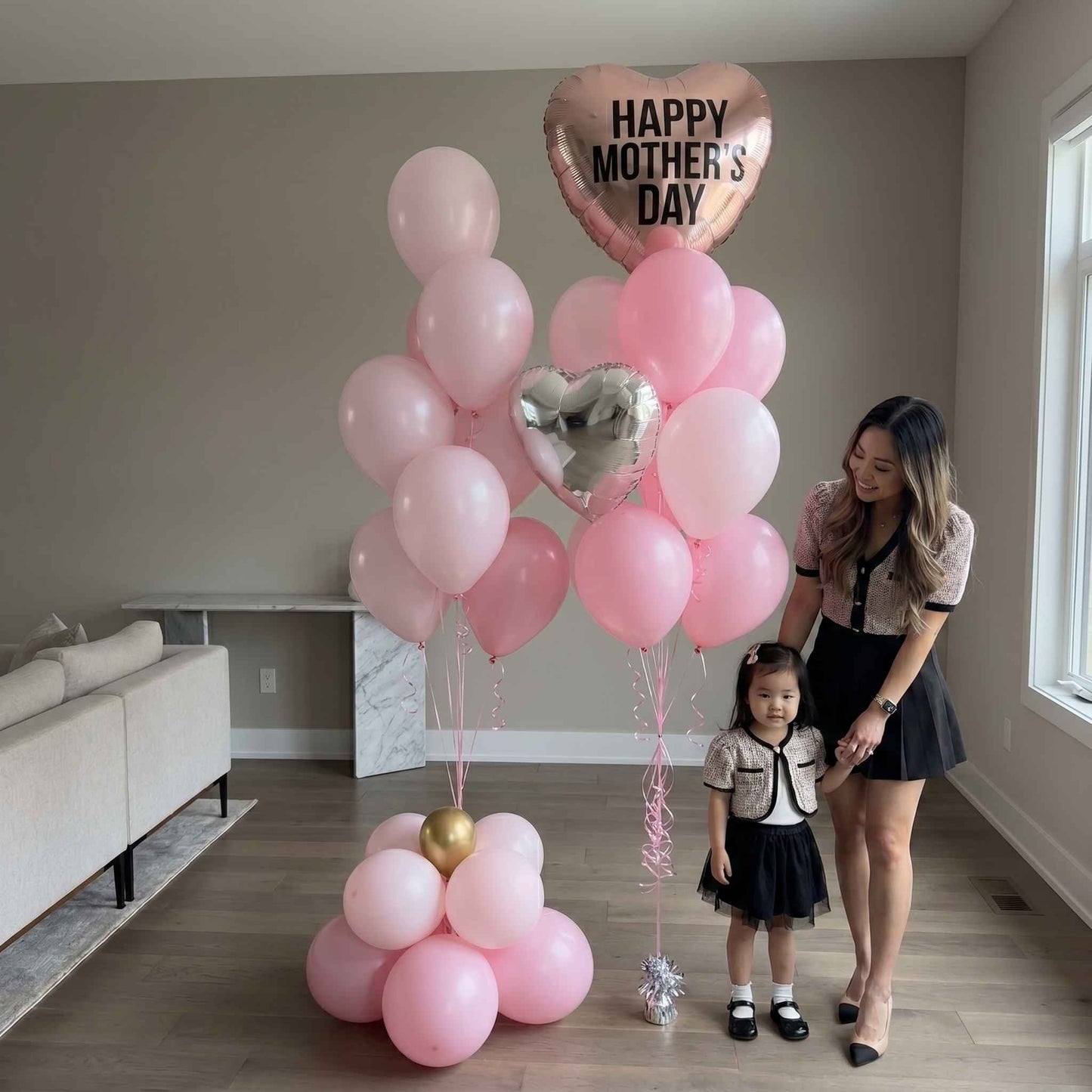 Mother and daughter with pink Mother’s Day balloons large apartment 