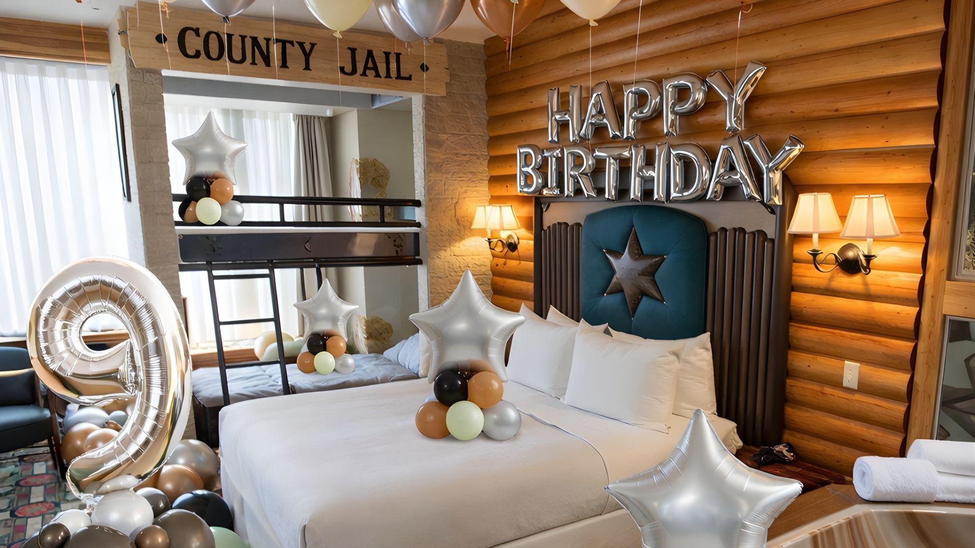 Decorated bedroom with 'Happy Birthday' sign and balloons, featuring a 'County Jail' theme.
