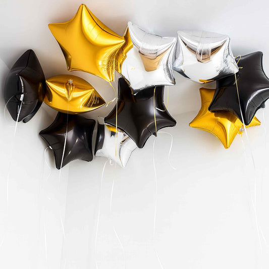 Star-shaped balloons in gold, black, and silver on a white background