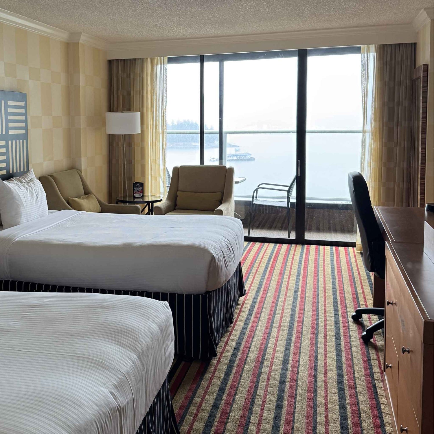 hotel room before a balloon install with a large window view of the water
