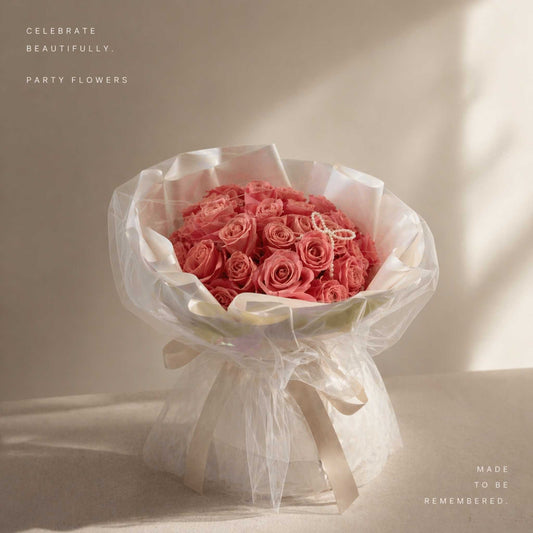 Bouquet of pink roses wrapped in white paper with a bow on a light background, featuring text 'Celebrate Beautifully. Party Flowers' and 'Made to be Remembered.
