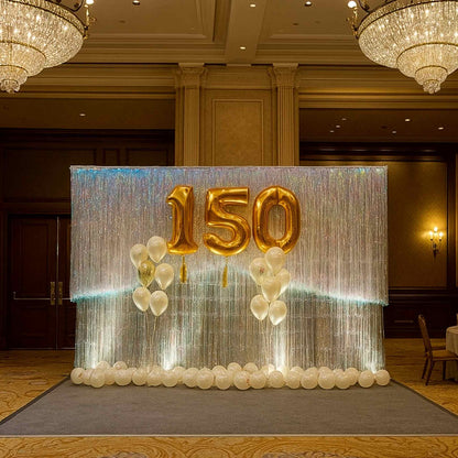 Decorative setup with '150' balloons in a formal event hall.