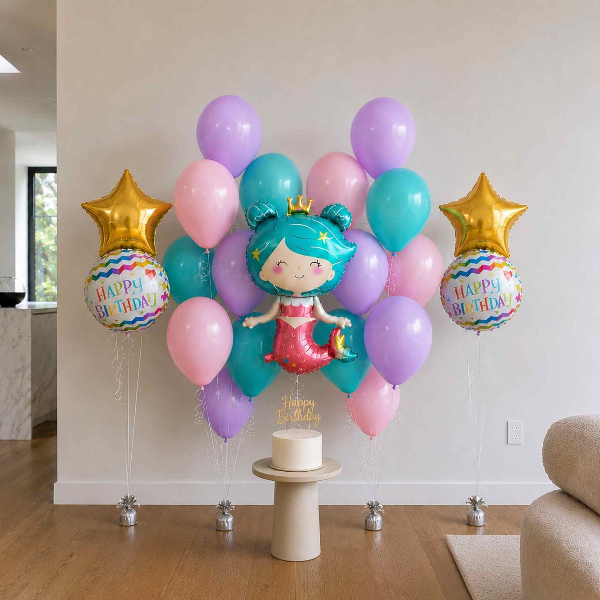 Colorful birthday balloons with a mermaid theme on a wooden floor.