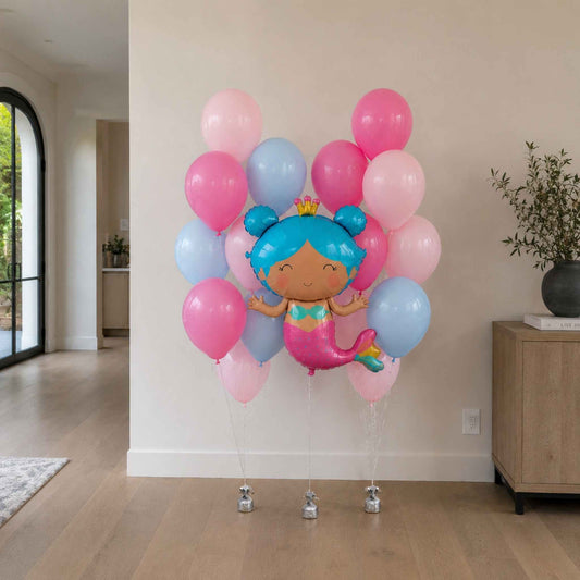 Balloon arrangement with a cartoon character in a room with a plant and furniture.