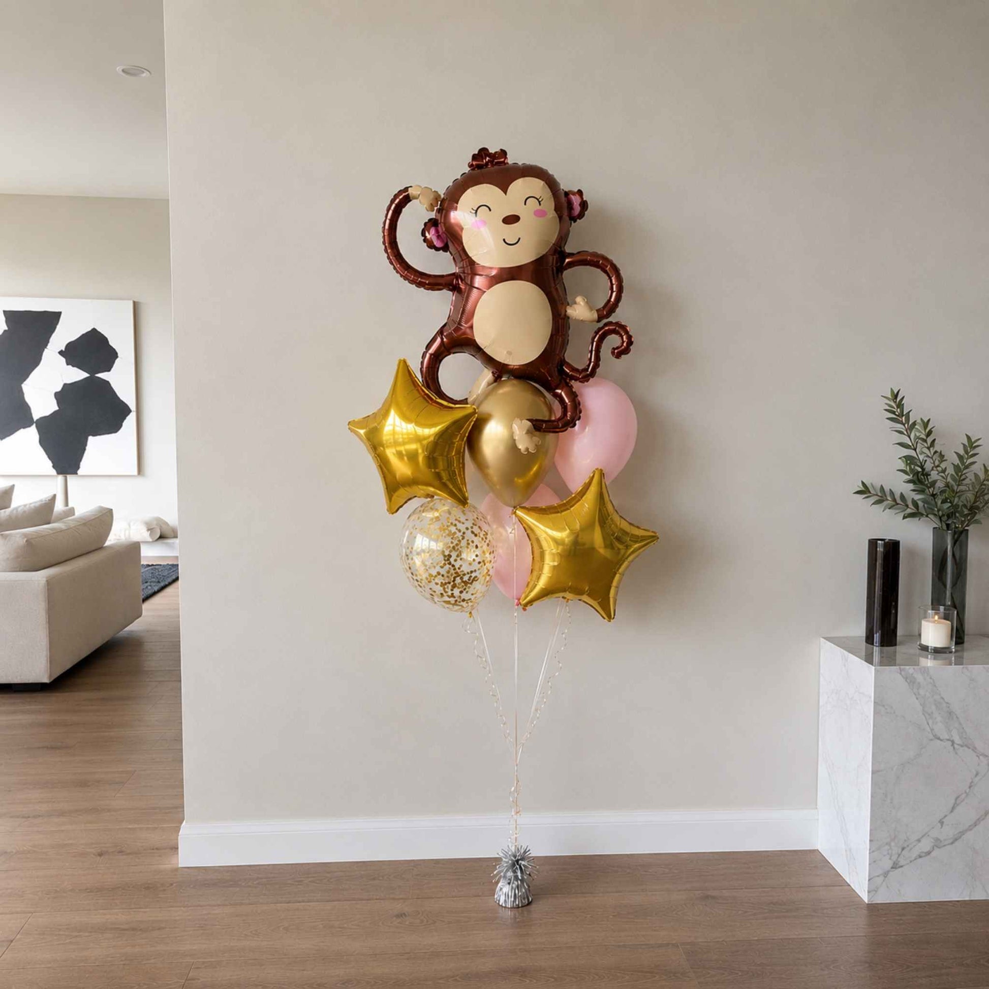 Balloon bouquet with monkey design in a living room setting
