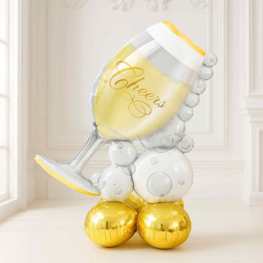 Decorative balloon shaped like a champagne glass with 'Cheers' text on a light background