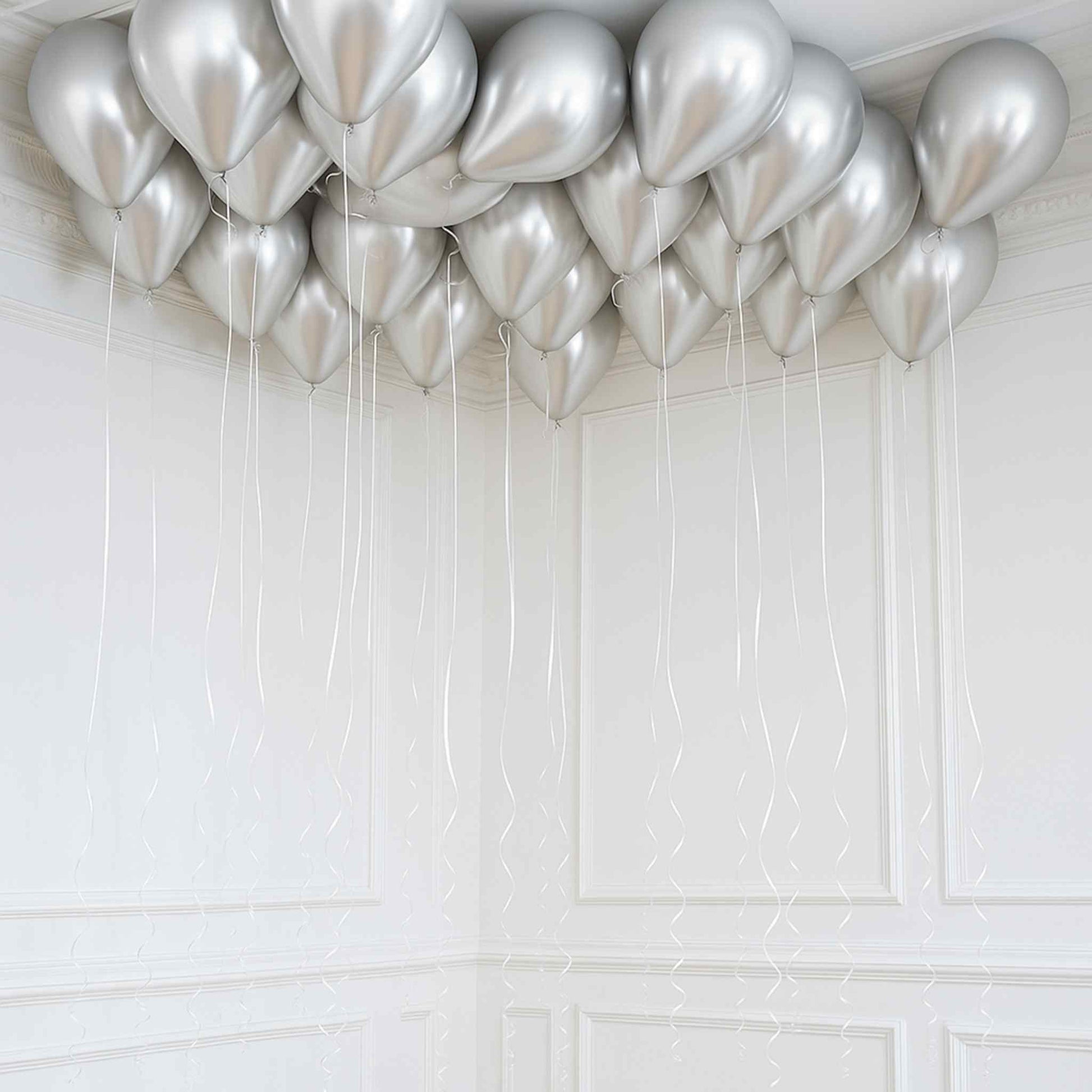 Silver balloons against a white tiled wall