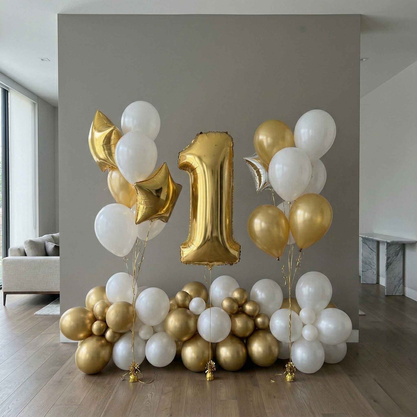 Gold and white balloons with a number '1' in a room setting