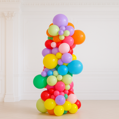 Colorful balloon arch against a white wall