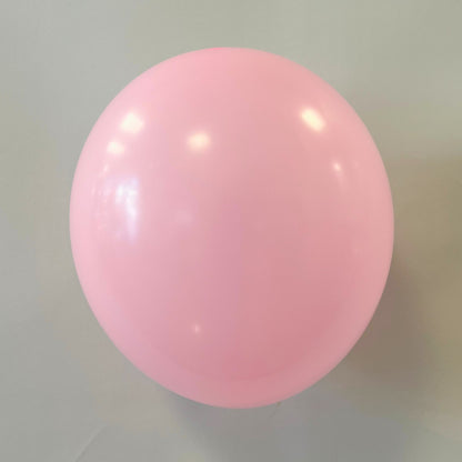 Single pink balloon against a neutral background