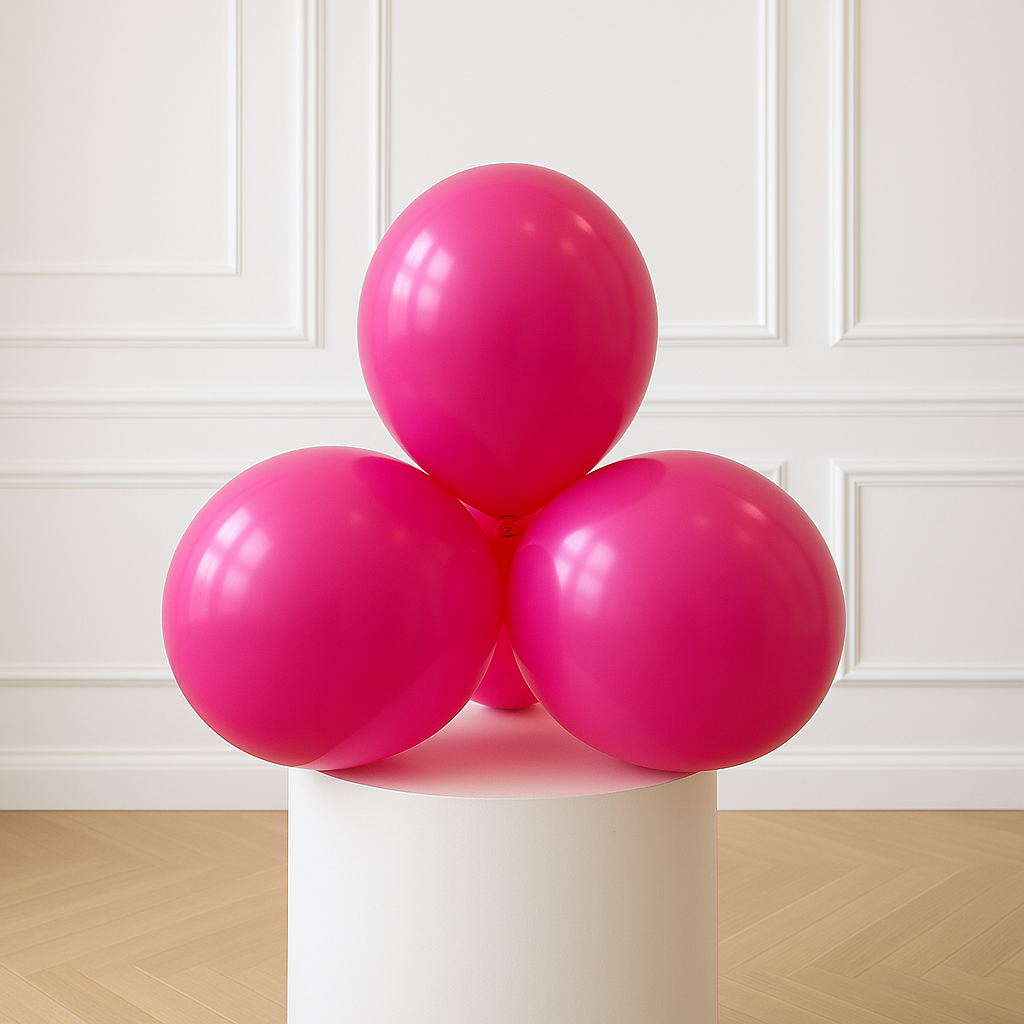 Three pink balloons on a white pedestal against a white paneled wall.