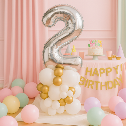 Silver number 2 balloon on a birthday-themed setup with balloons and cake.