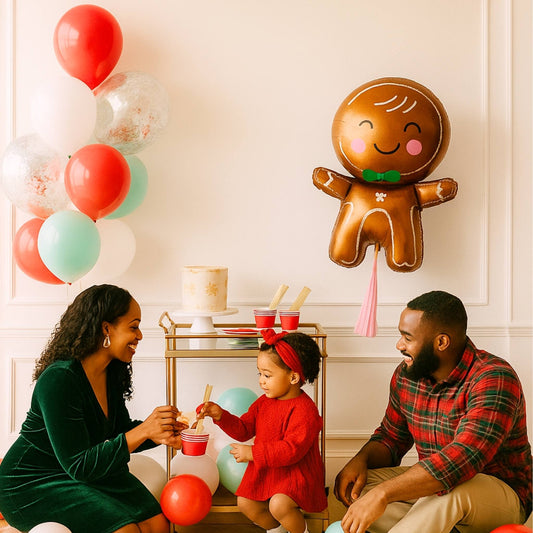 Family of three with a gingerbread man balloon in a festive setting.