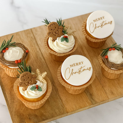 Decorative cupcakes with 'Merry Christmas' on a wooden board