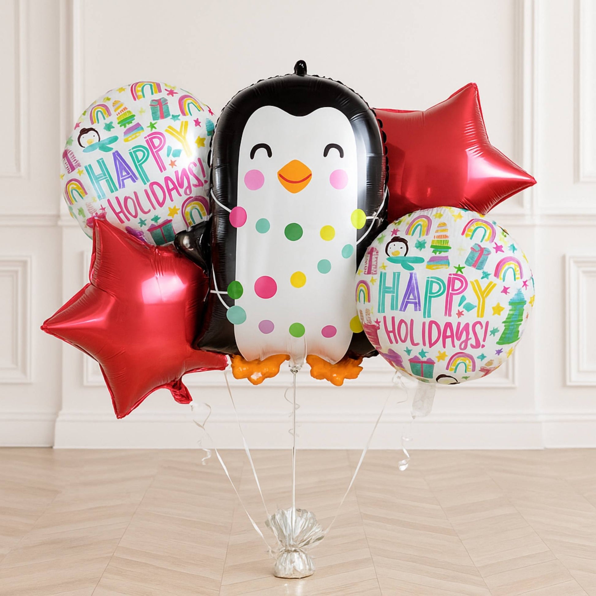 Set of festive balloons with penguin design and 'Happy Holidays!' text on a white background.