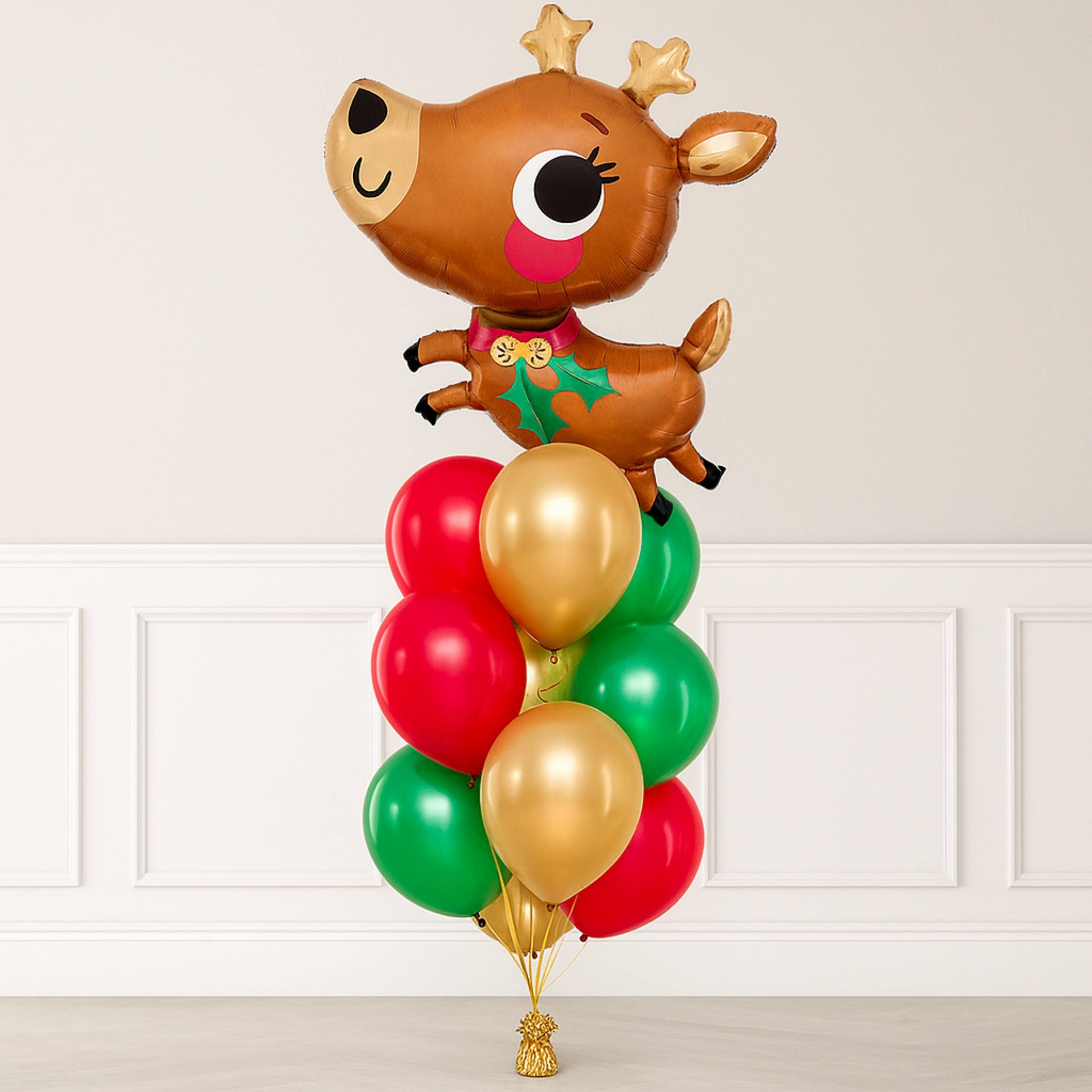 Balloon arrangement with a reindeer design on a white wall background