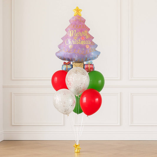 Colorful Christmas tree-shaped balloon with red, green, and white balloons against a white paneled wall.
