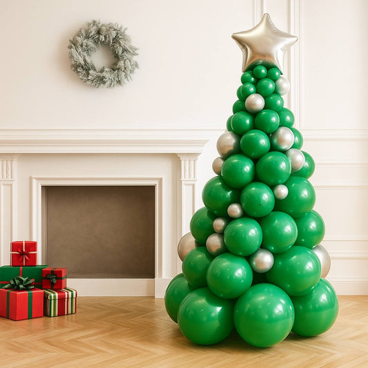 Balloon Christmas tree with green and silver balloons in a room with a fireplace and wreath.