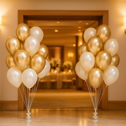 Two bunches of gold and white balloons in a room with a mirror and light fixture.