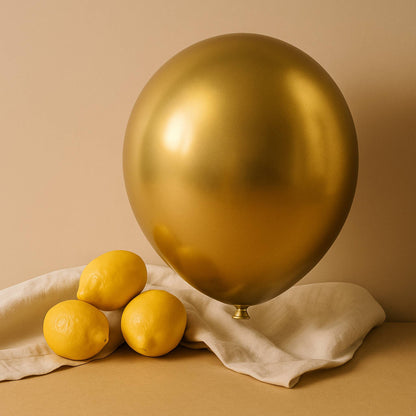 Gold balloon and lemons on a beige background