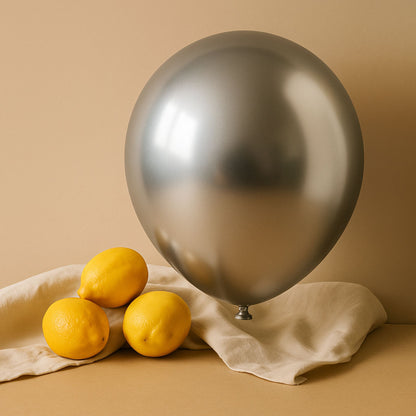 Chrome Silver 11 inch helium balloon and lemons on a beige background