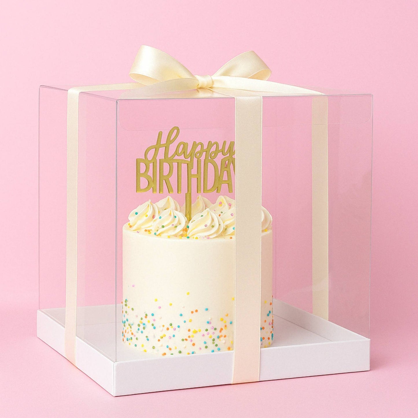 Gift box with a birthday cake inside, featuring a 'Happy Birthday' message on a pink background.