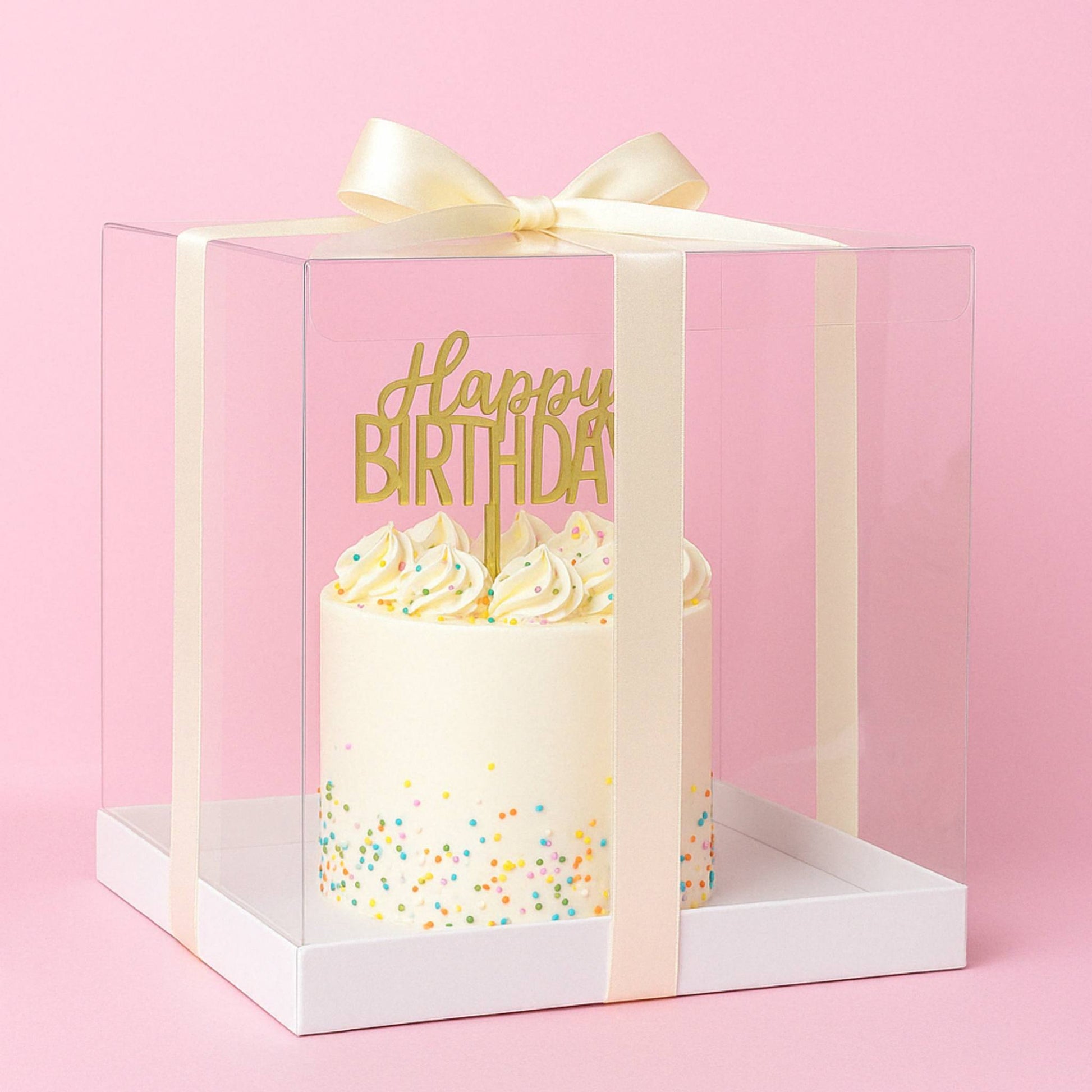 Gift box with a birthday cake inside, featuring a 'Happy Birthday' message on a pink background.