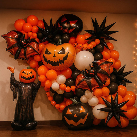 Halloween-themed balloon arrangement with pumpkins, bats, and ghosts on a neutral background.