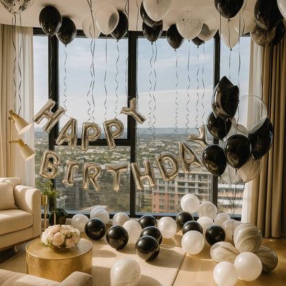 Decorated room with 'Happy Birthday' balloons and a cityscape view through large windows.