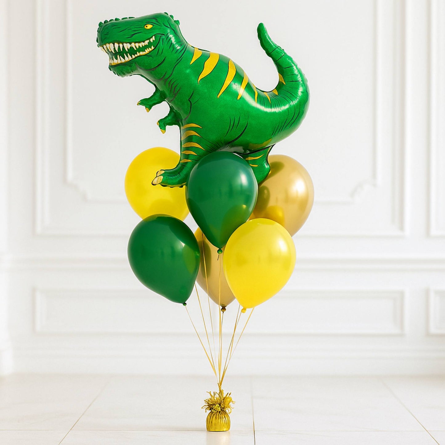 Dinosaur-shaped balloon surrounded by green, yellow, and gold balloons on a white background
