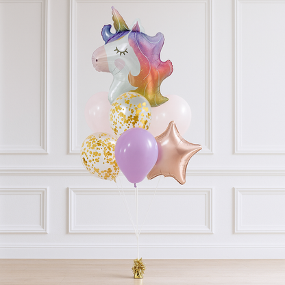 Colorful unicorn-shaped balloon with other balloons against a white paneled wall.