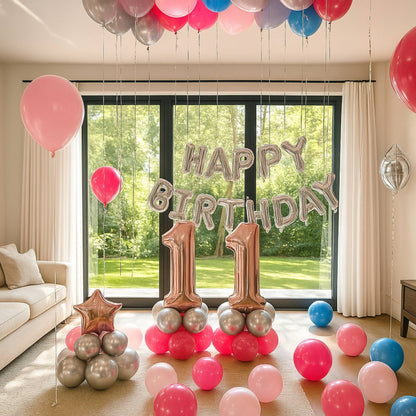 Birthday celebration with balloons and 'Happy Birthday 11' banner in a room with large windows.