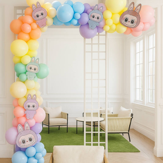 Colorful balloon arch with cartoon Labubu in a room with chairs and a table.