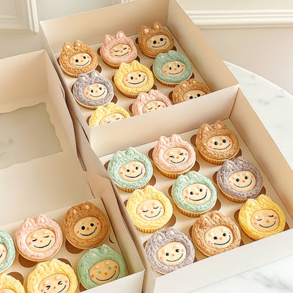 Box of cupcakes with labubu face designs on a light background