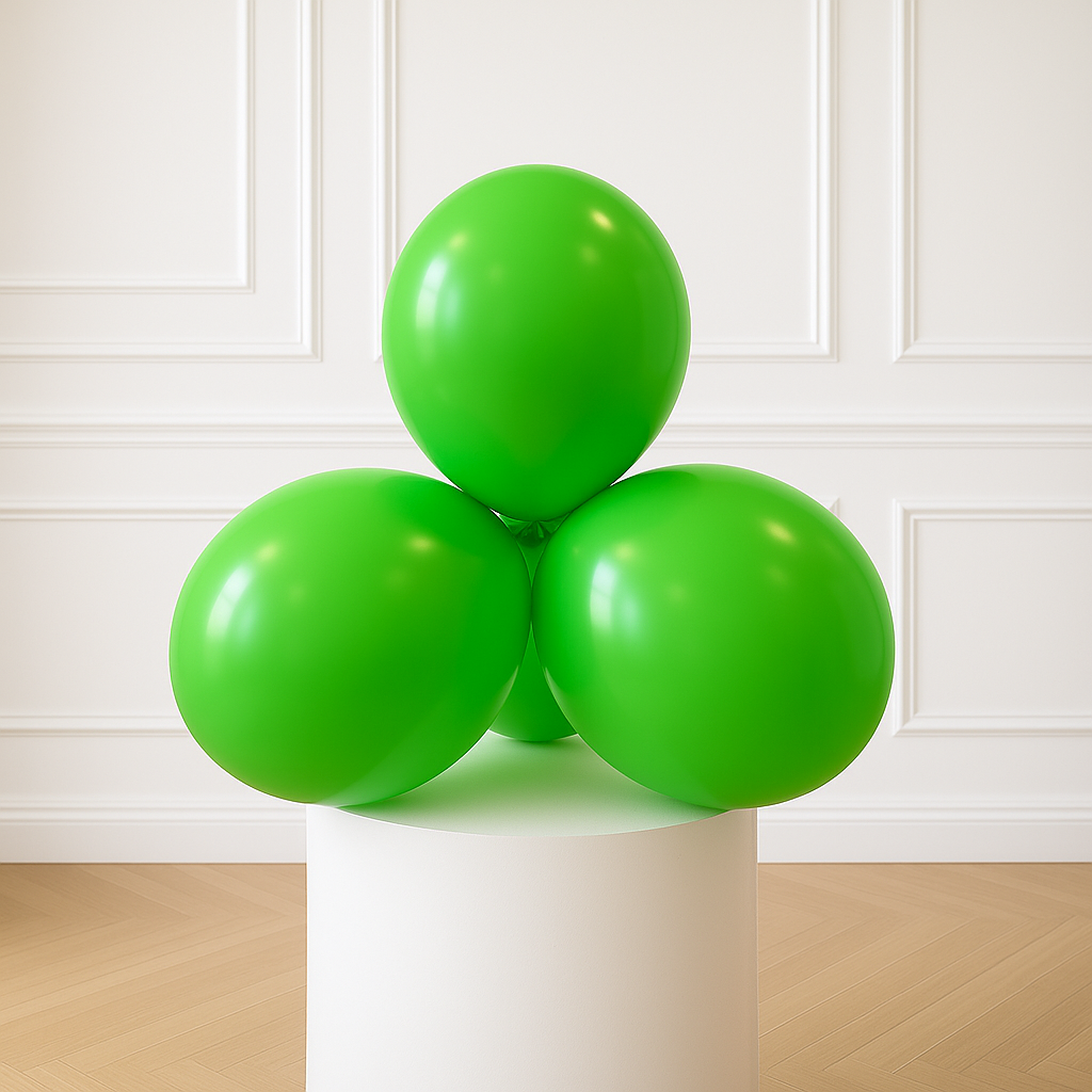 Three green balloons on a white pedestal against a white paneled wall.