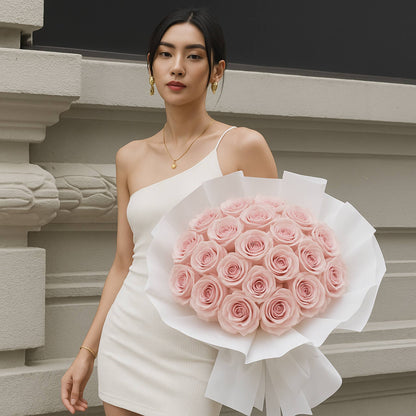 Woman holding a bouquet of pink roses against a neutral background
