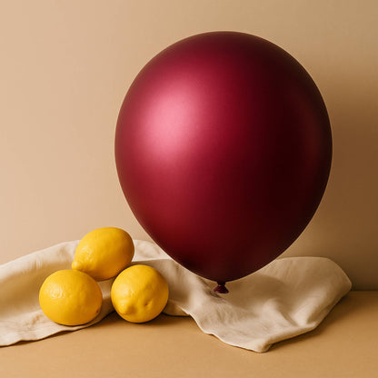 Red balloon and lemons on a beige surface with a beige background