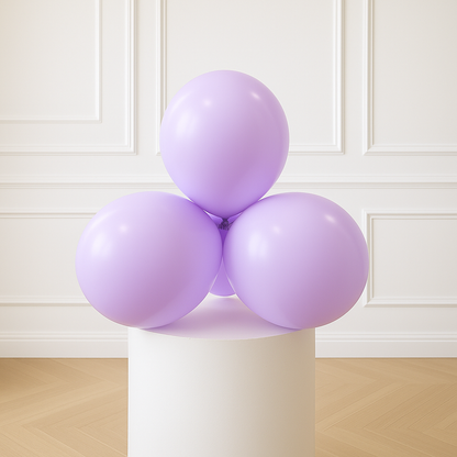 Four pastel purple balloons on a white pedestal against a white paneled wall.
