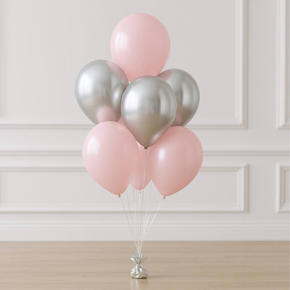 Bouquet of pink and silver balloons on a neutral background