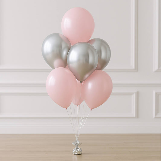 Bouquet of pink and silver balloons on a neutral background