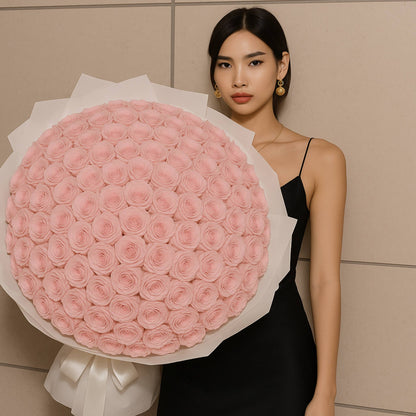 Woman holding a large bouquet of pink roses against a neutral background