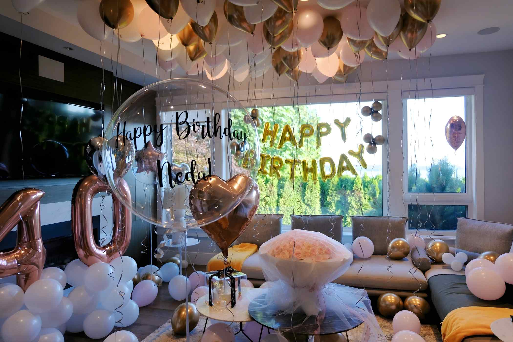 Birthday celebration with balloons and decorations in a living room.