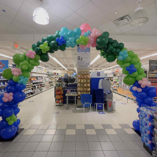 Balloon arch in a grocery store with colorful balloons