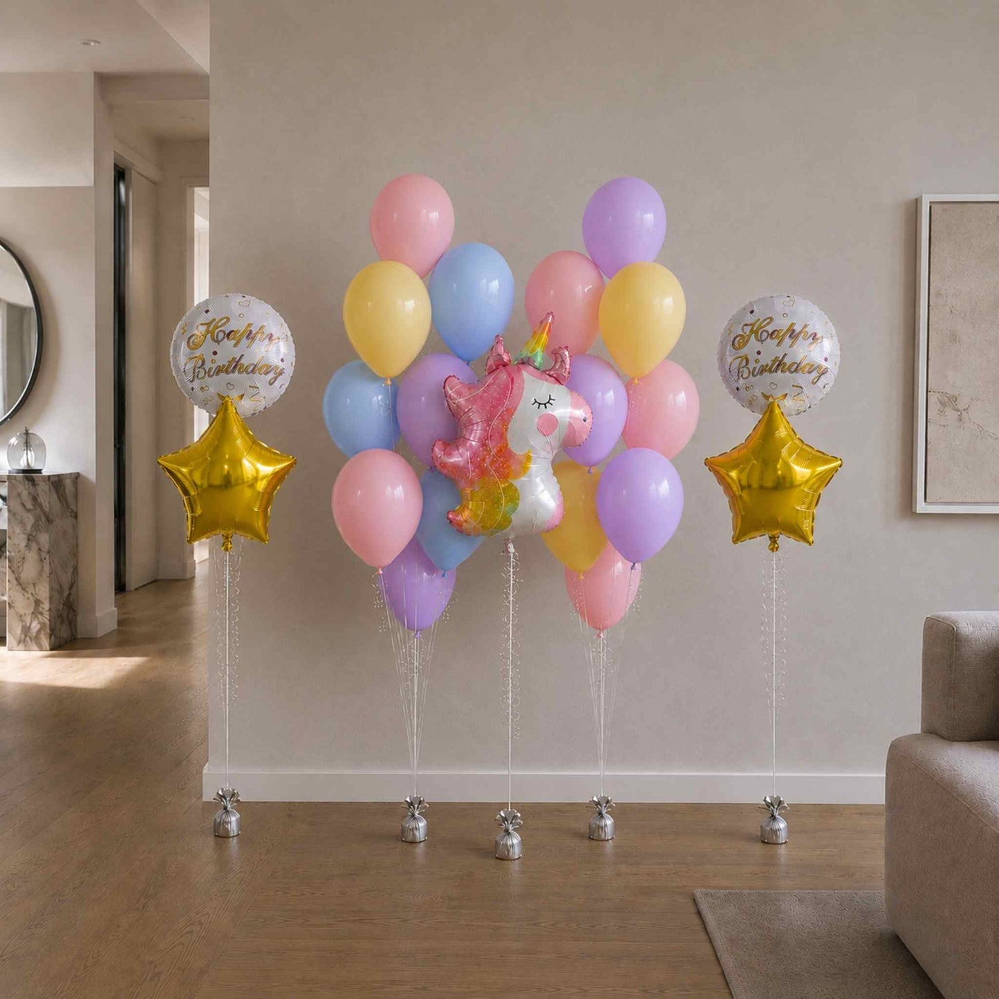 Colorful balloons with a unicorn and star shapes in a living room setting.