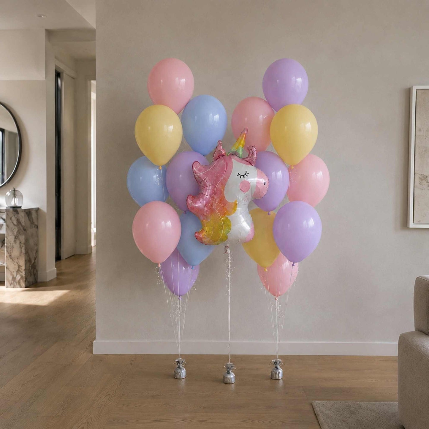 Colorful balloons with a unicorn balloon in a living room setting