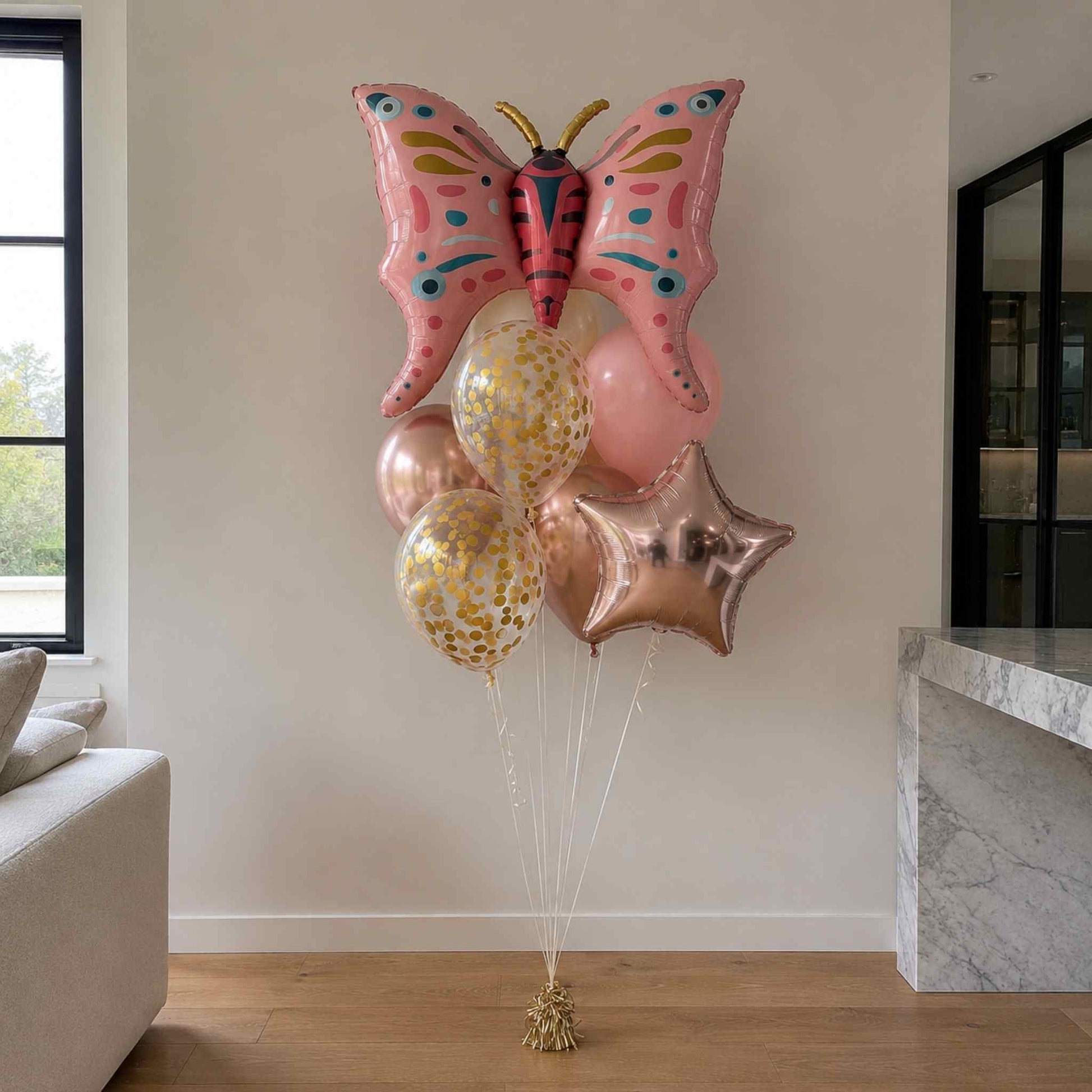Butterfly-shaped balloon with other balloons in a living room setting