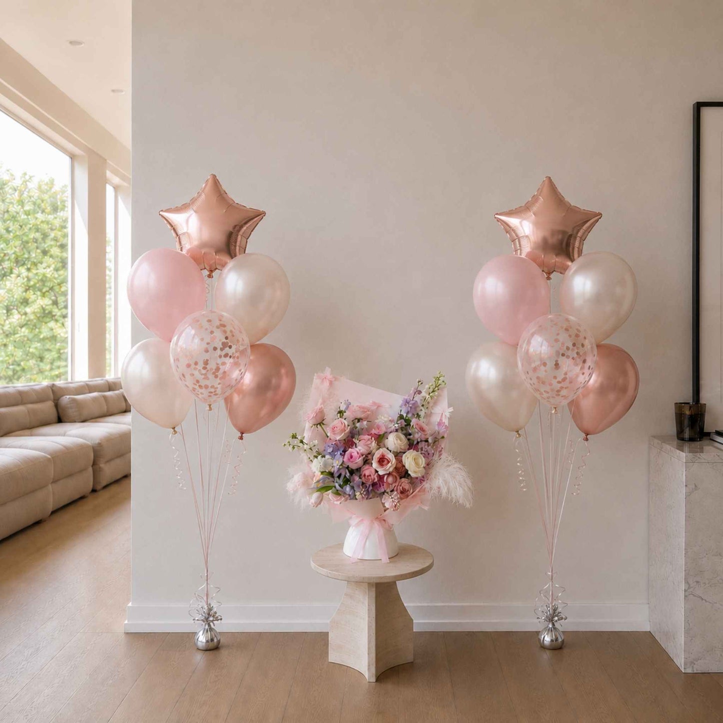 Decorative balloons with star shapes and a bouquet of flowers on a small table in a room.
