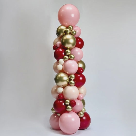 luxury balloon tower gold with red hue studio shot