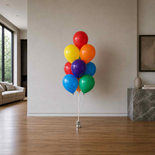 Colorful balloons in a living room setting with a neutral wall and furniture.